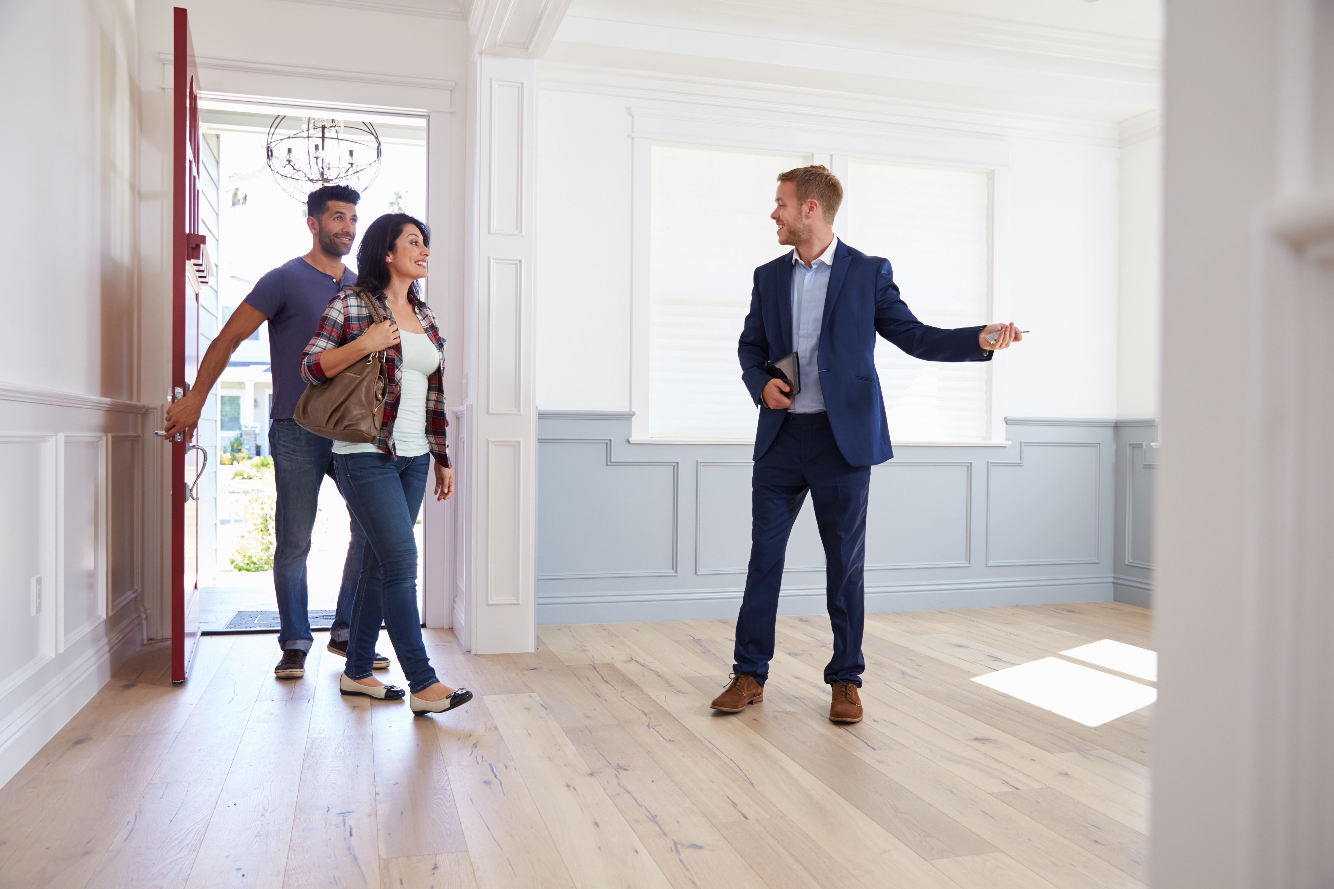 A couple viewing a property with an estate agent