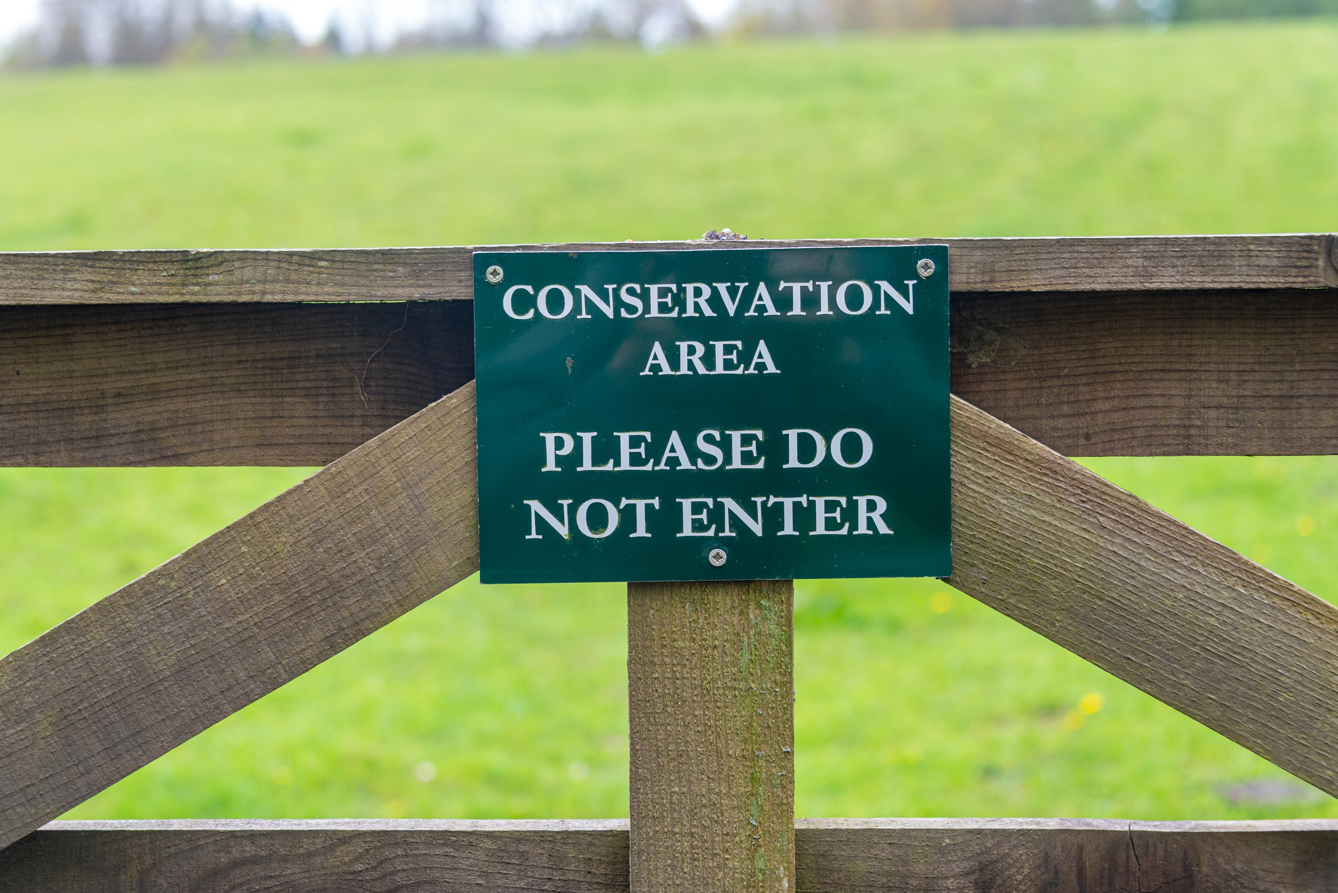 Conservation area sign on wooden gate